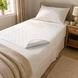 Confio Bed Pad laid on a made single bed