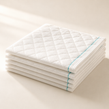 Confio Bed Pads – stack of quilted absorbent bed pads